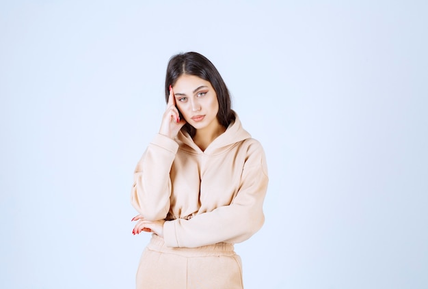 Young woman looks thoughtful as she is thinking and planning