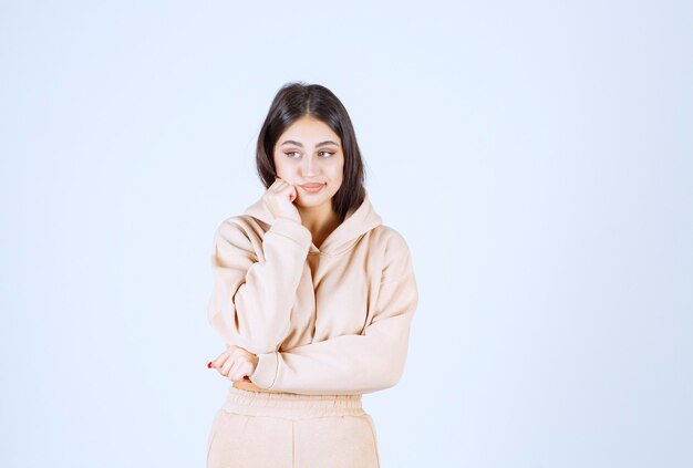 Young woman looks thoughtful as she is thinking and planning