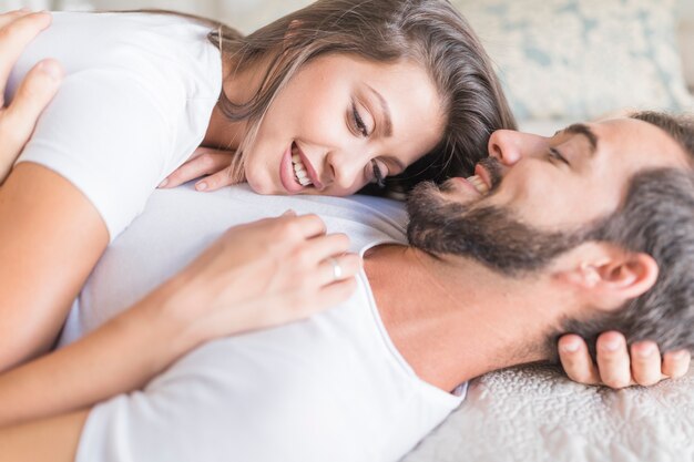 Young woman lying on chest of boyfriend