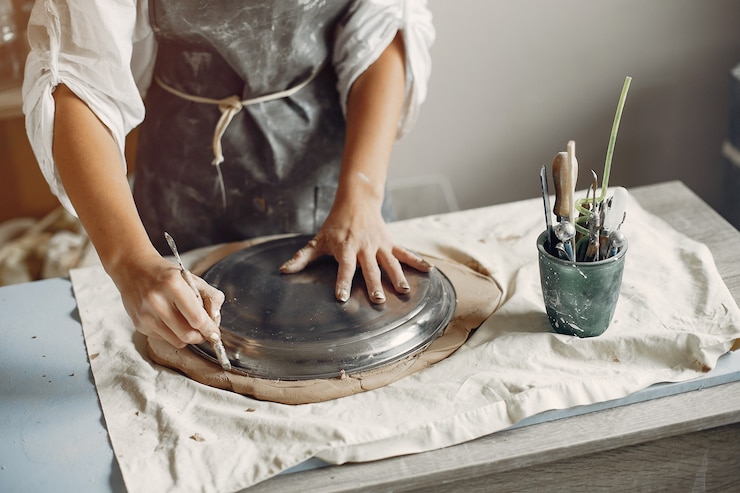 Free Photo young woman makes pottery in workshop