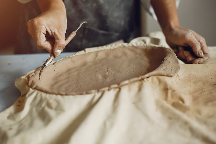 Free Photo young woman makes pottery in workshop