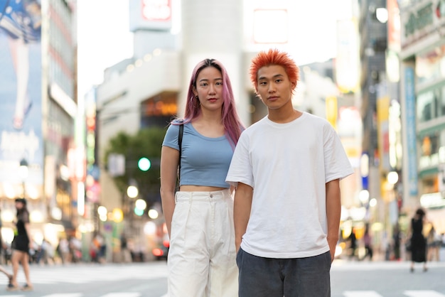 Free photo young woman and man with fun hair colors