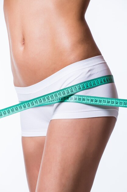 Young woman measuring perfect shape of beautiful thigh healthy lifestyles concept