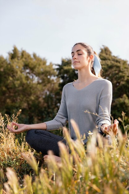 Young woman meditating in nature