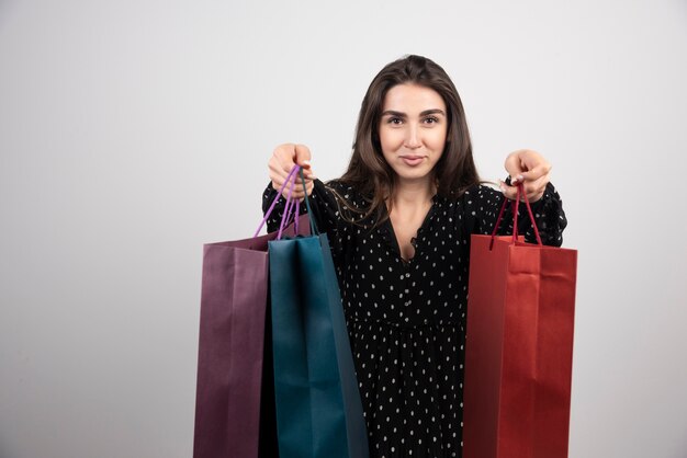 Young woman model carrying a lot of shopping bags 