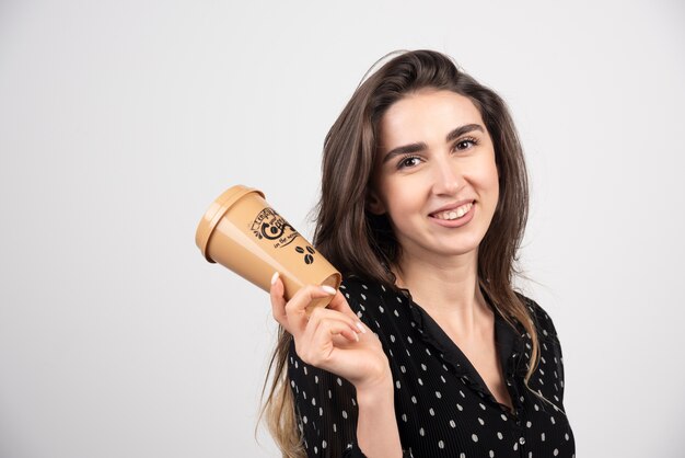 Young woman model holding a coffee cup