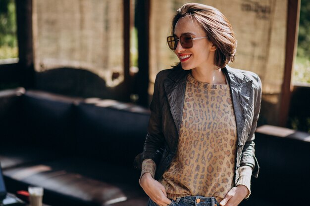 Young woman model in jacket posing outside