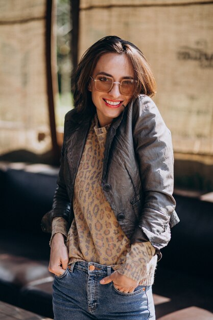 Free photo young woman model in jacket posing outside