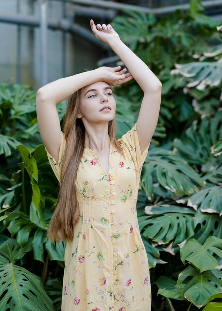 Young woman model posing in greenhouse