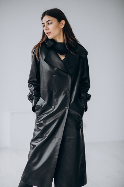 young woman model wearing long black leather coat