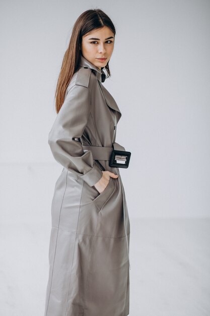 Young woman model wearing long grey coat