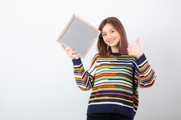 young woman model with a frame showing a thumb up.