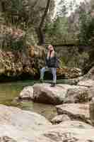 Free photo young woman in nature at river