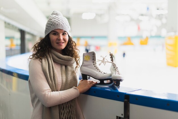 Young woman near skating rink