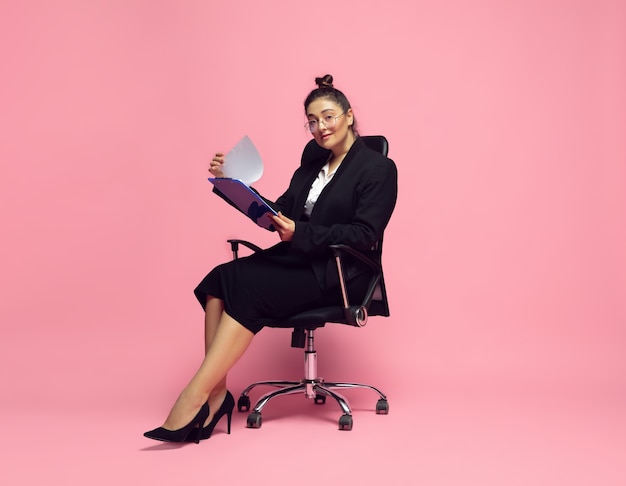 Young woman in office attire. Plus size businesswoman