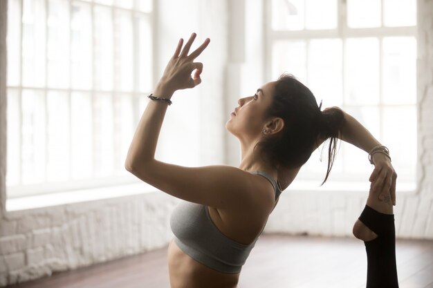 Young woman in One Legged King Pigeon pose