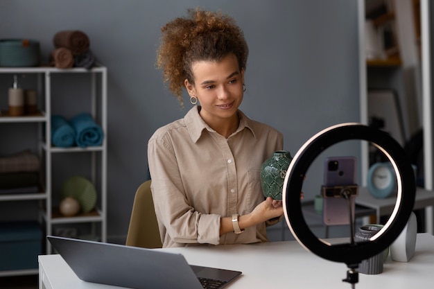 Free photo young woman organizing live shop