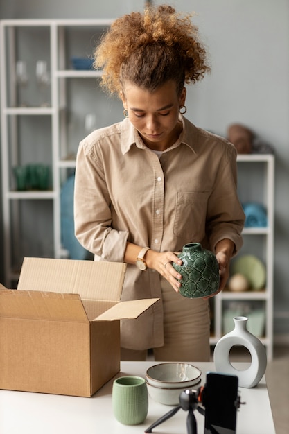 Free photo young woman organizing live shop