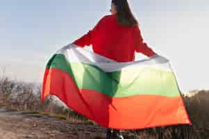 Free photo young woman outdoors holding the bulgarian flag