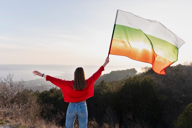 young woman outdoors holding the bulgarian flag