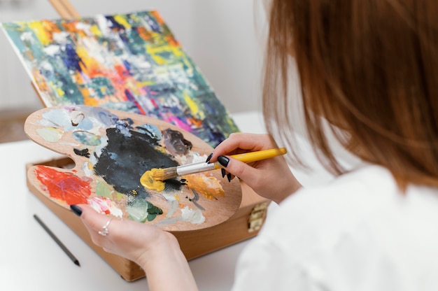 Young woman painting with acrylics