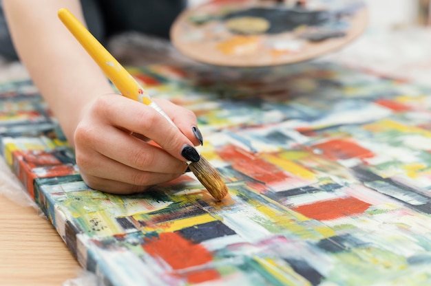 Young woman painting with acrylics