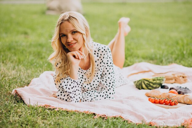 Young woman in park eating watermelon