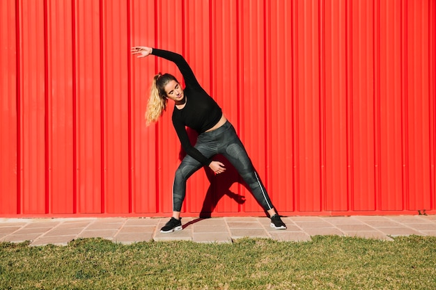 Young woman performing side bending