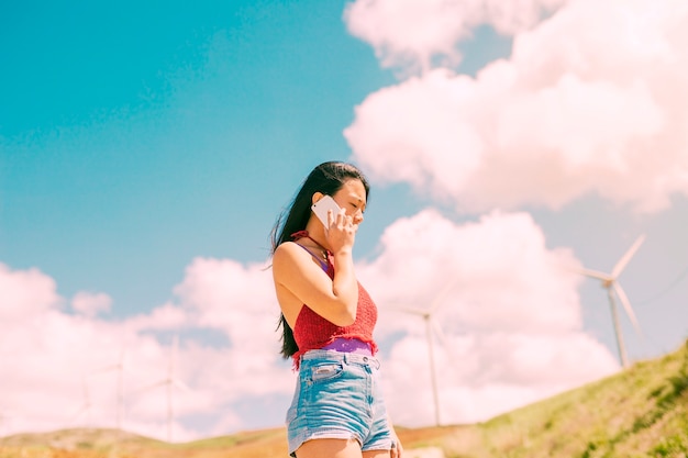 Young woman phoning with thoughtful look