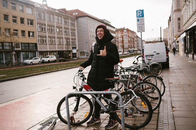 Young woman picks up her bike from the parking lot