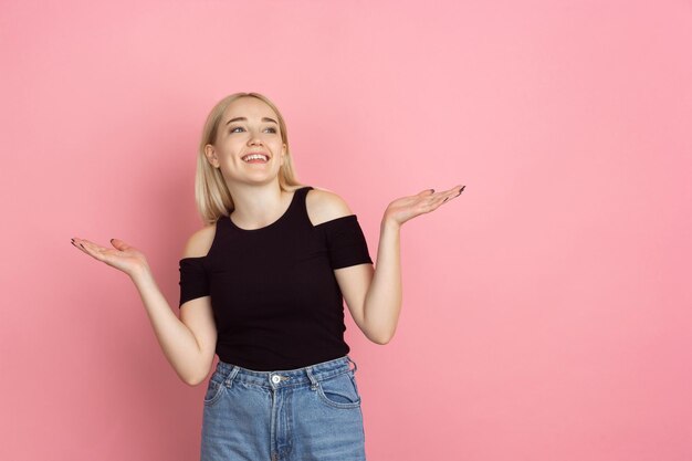 Young woman on pink background, copyspace