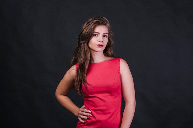 Young woman in pink dress looking at camera