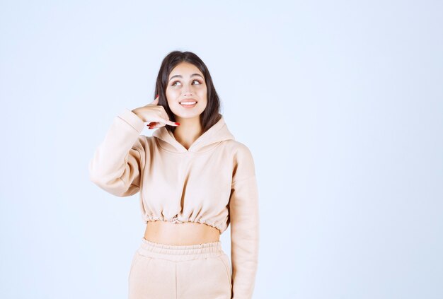 Young woman in a pink hoodie asking to call