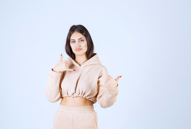 Young woman in a pink hoodie asking to call