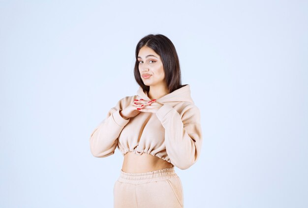 Young woman in a pink hoodie giving lovely and heartful poses