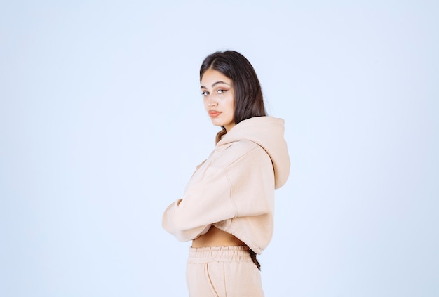 Young woman in a pink hoodie looking behind