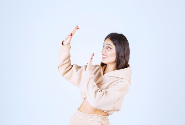 Young woman in a pink hoodie stopping someone