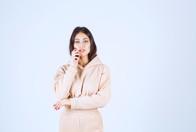 Young woman in a pink hoodie thinking and brainstorming