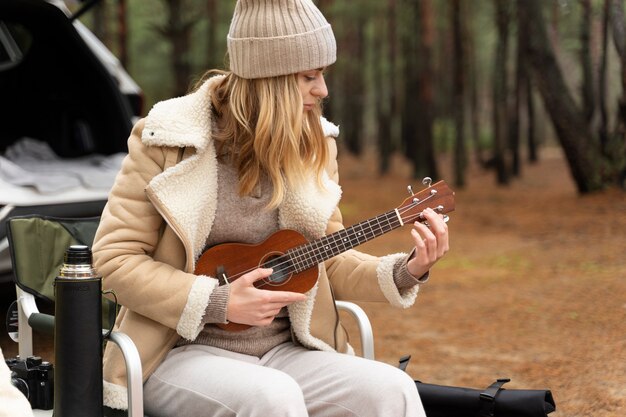 Young woman playing banjo during camp