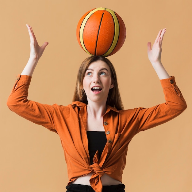 Young woman playing basketball ball