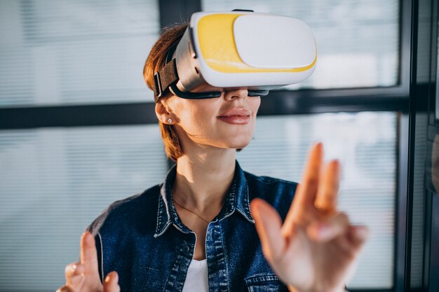 Young woman playing game through the VR glasses