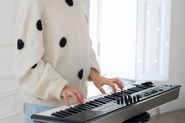 Young woman playing the piano indoors