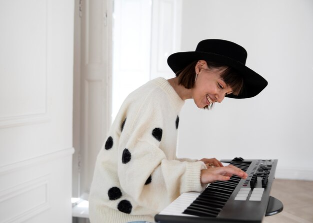 Young woman playing the piano indoors