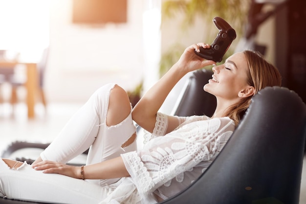 Young Woman Playing Playstation At Home