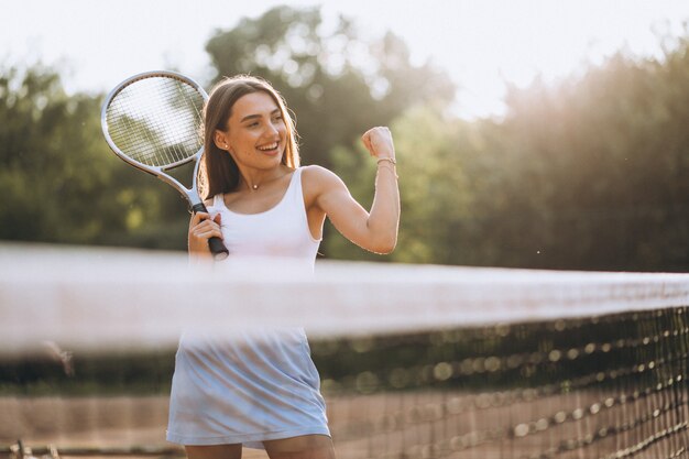 Young woman playing tennis at the court