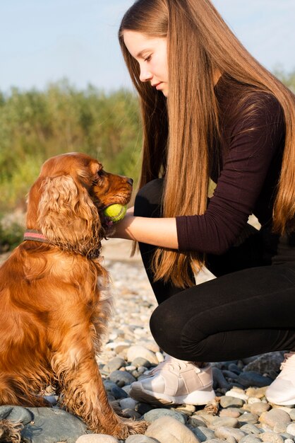 彼女の犬と遊ぶ若い女性