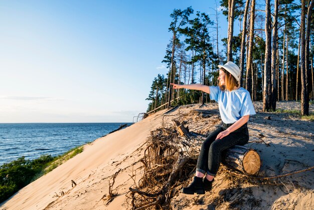 Young woman pointing at distance