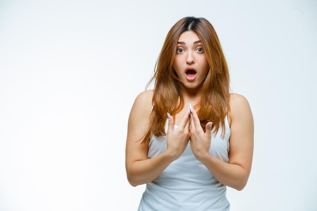 Young woman pointing at herself in shock