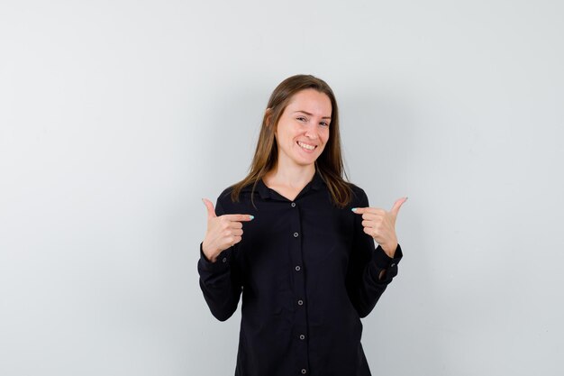 Young woman pointing at herself