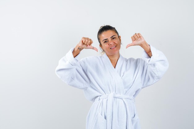 Young woman pointing to herself